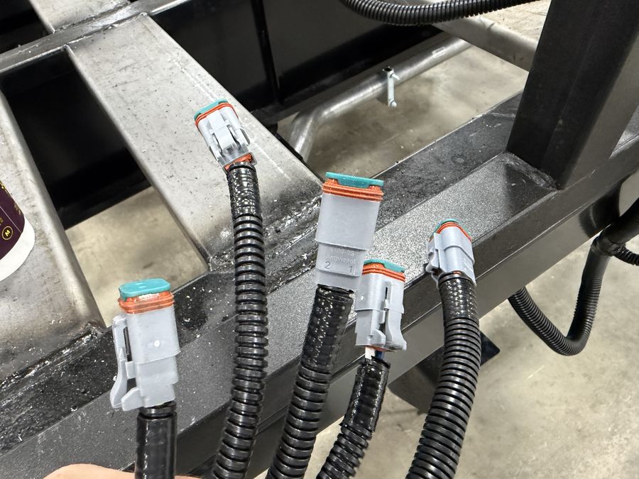 Sealed automotive-grade electrical connectors in an HLE bus frame
