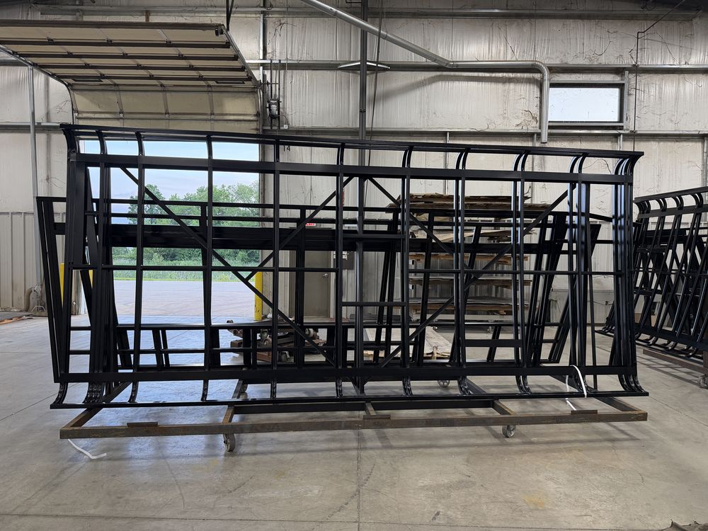 Welded, powder-coated steel cage of a custom HLE vehicle build taking shape at the Wakarusa plant