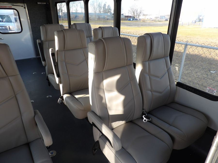 Bright HLE shuttle bus interior with high-back seating