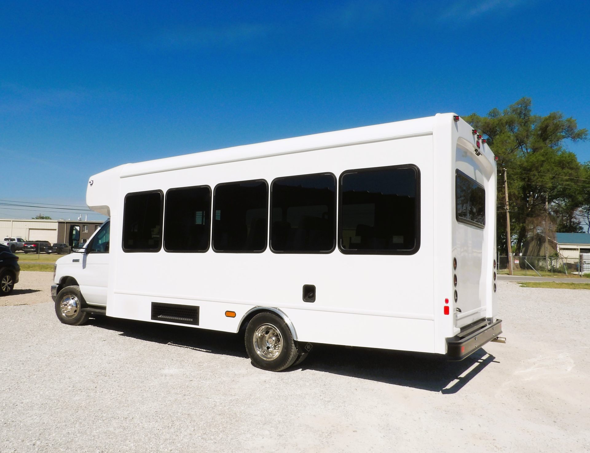 HLE Mavryk shuttle bus on the Ford E-450 chassis, driver-side angle under blue sky