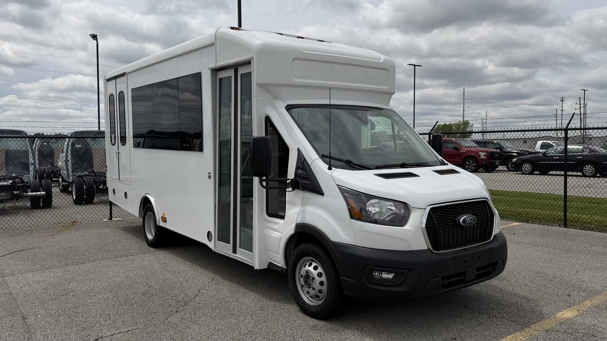 HLE Strykr Ford Transit shuttle, front three-quarter view outdoors