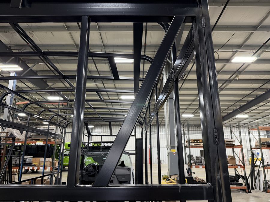 Welded, powder-coated steel-cage frame under construction at the HLE plant