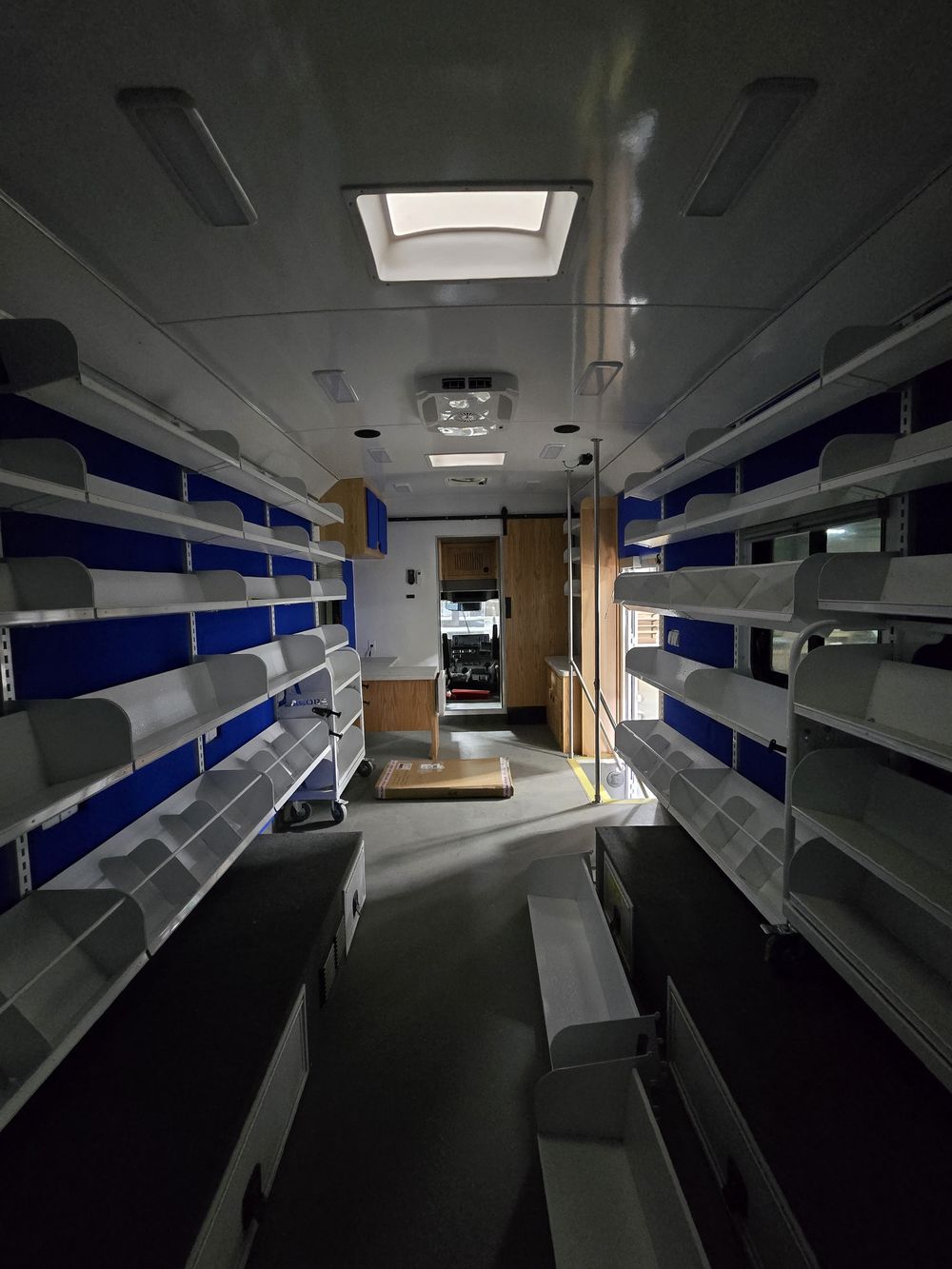 Interior of a mobile library vehicle with custom shelving