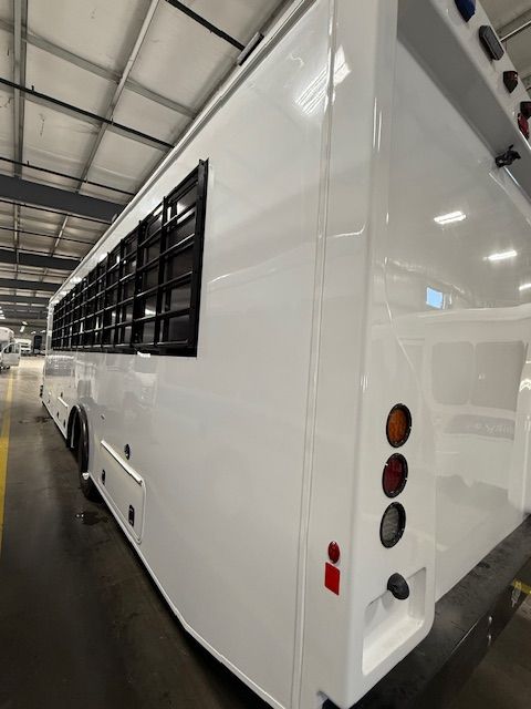 Secure transport bus side profile with security window guards